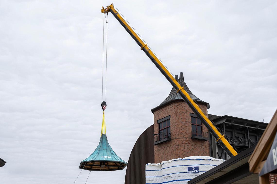 A crane lifts a rooftop onto Starlight Theatre during construction on Feb. 17, 2025, in Kansas City. The installation is part of the venue’s Uniquely KC capital campaign.