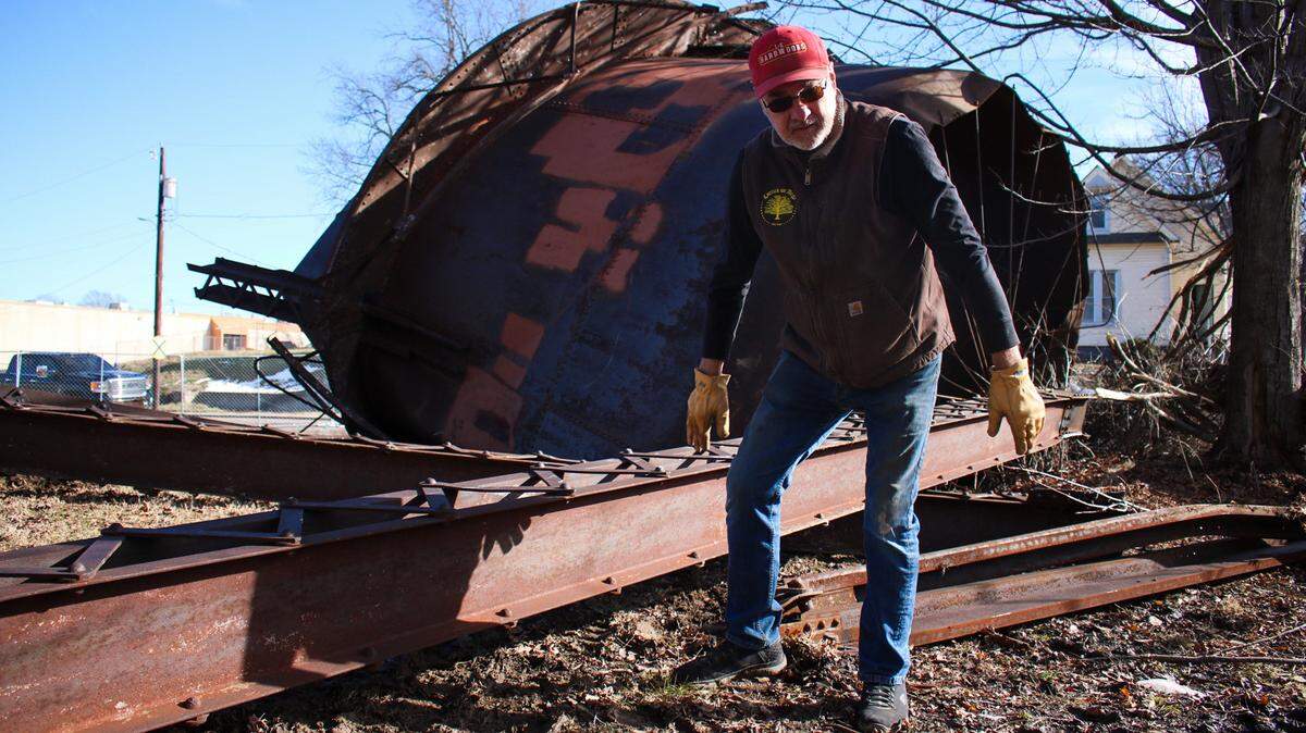 Mark Carrick, a member of the Jackson County Historical Society, surveys a 112-year-old water tower that was demolished in Independence Tuesday. The Historical Society plans to preserve and reuse some of the steel.