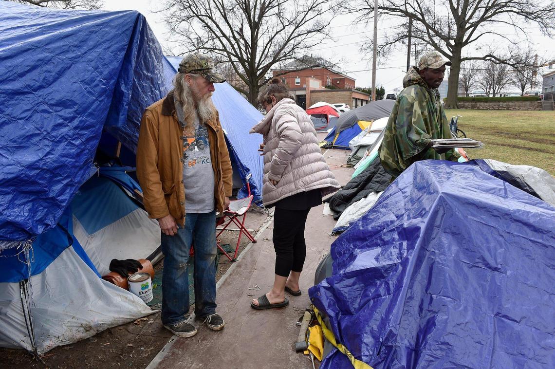 James Hanson, from left, Ashlea Gray and Peter Simon Louis live in “Camp 6ixx” in Westport. “We feed them, make sure they stay warm, give them clothes,” Gray said.