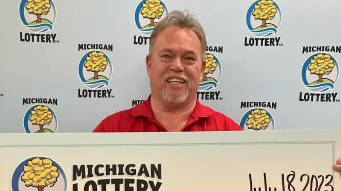 Greg Escue with his oversized check.