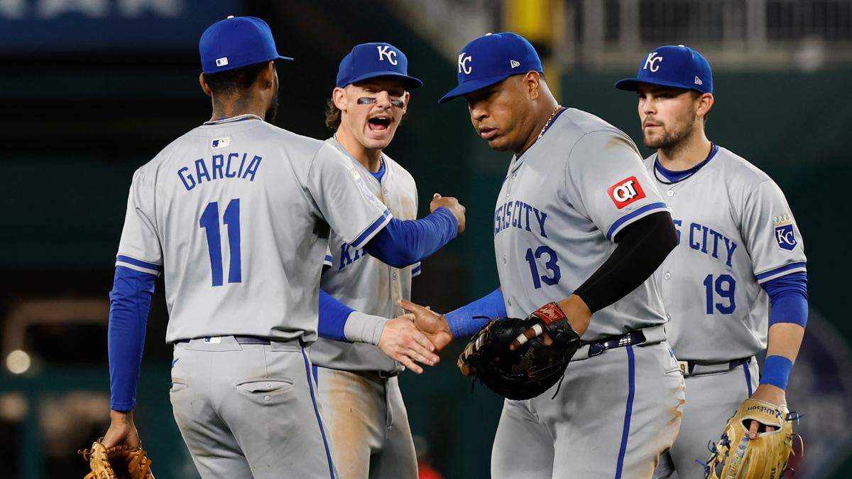 Kansas City Royals third baseman Maikel Garcia (11), shortstop Bobby Witt Jr. (7), first baseman Salvador Perez (13) and second baseman Michael Massey (19) celebrate after a game against the Washington Nationals at Nationals Park on Sept. 24, 2024.