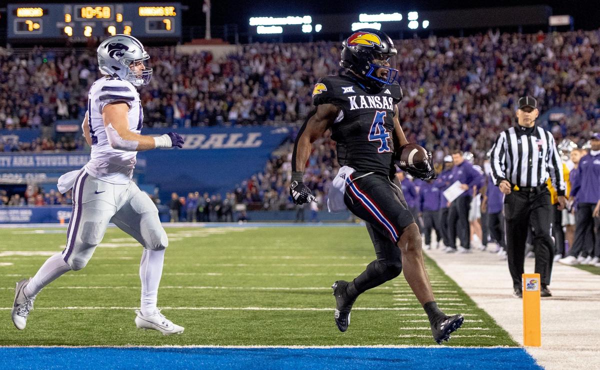 Kansas Jayhawks running back Devin Neal (4) beats Kansas State Wildcats linebacker Austin Moore (41) to the end zone for a score during an NCAA college football game on Saturday, Nov. 18, 2023, in Lawrence, Kan.