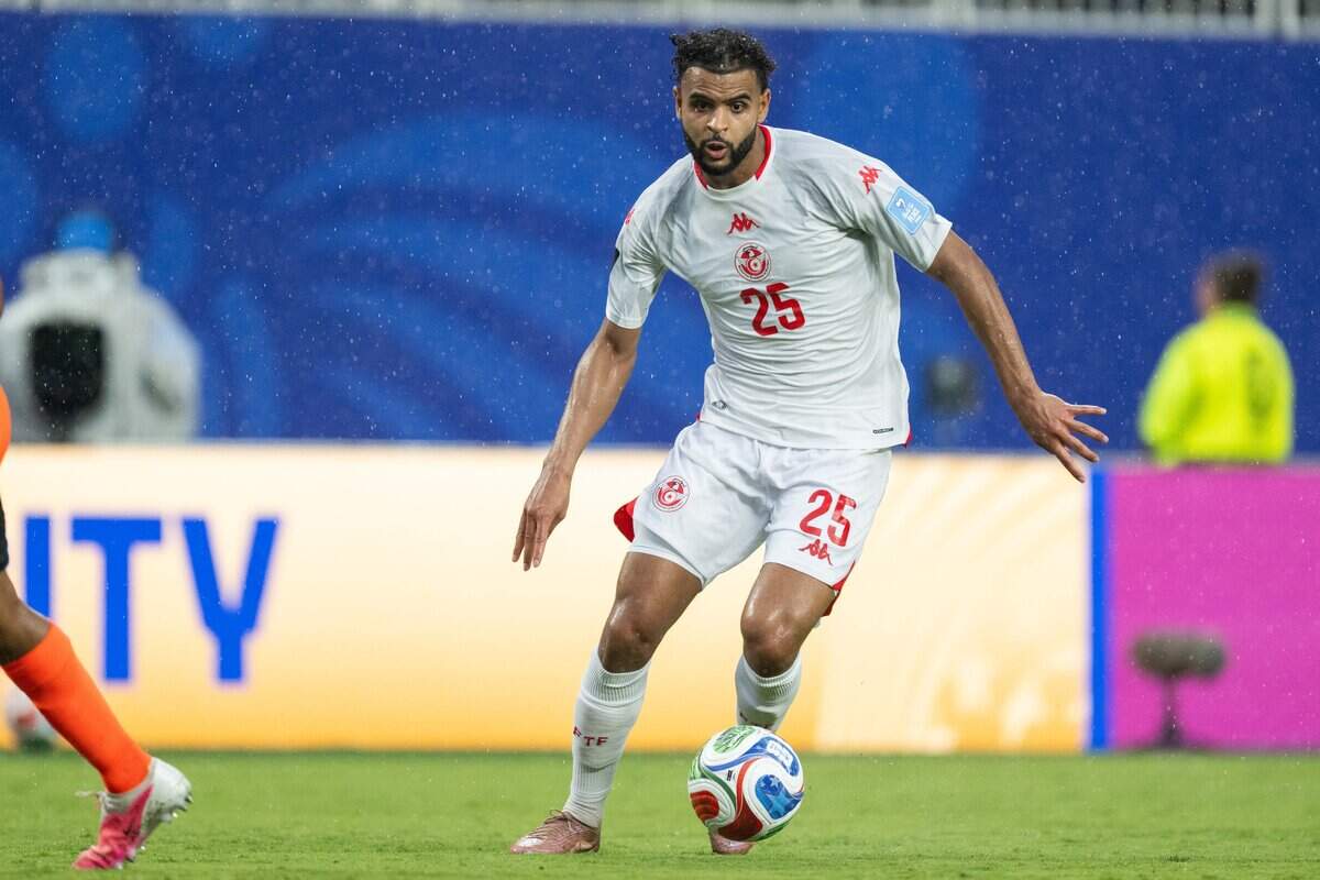 Tunisia midfielder Anis Ben Slimane (25) dribbles the ball in the rain in a FIFA World Cup group-stage soccer match at Kansas City (Arrowhead) Stadium in Kansas City on Thursday, June 25, 2026.