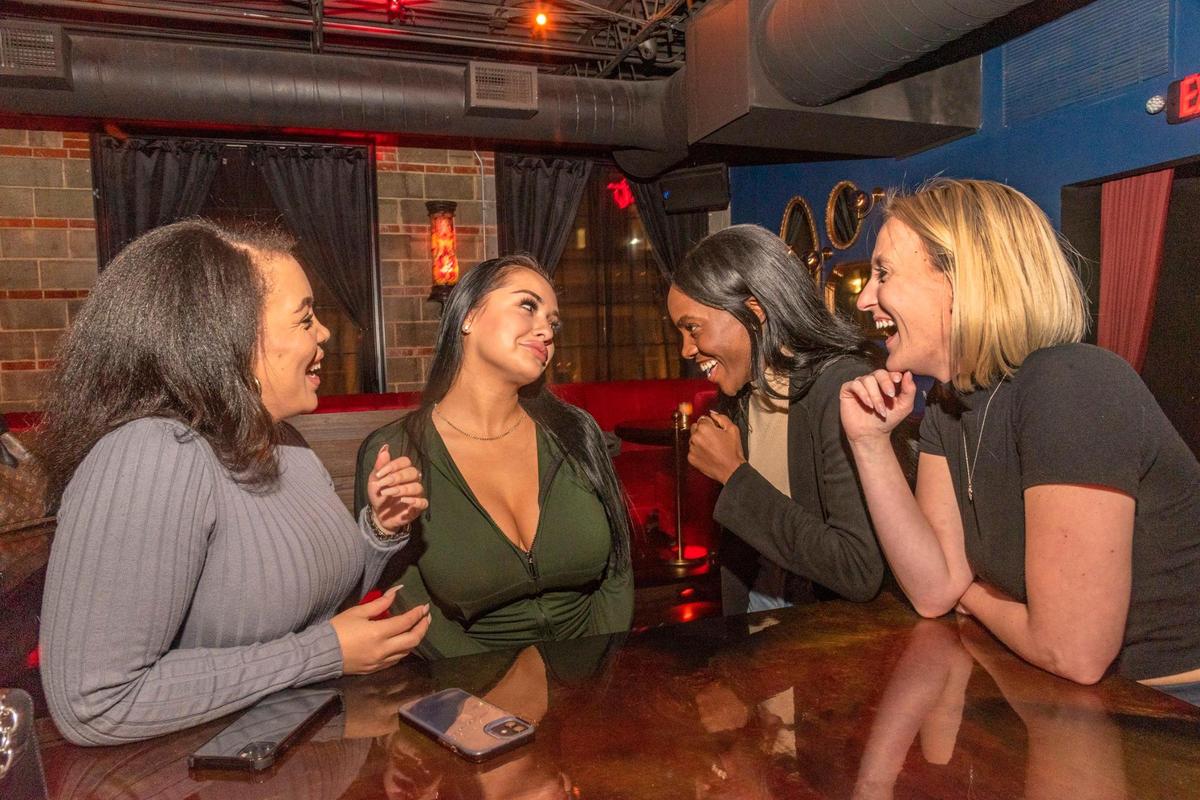 Kirby Appollis, from left, Brittany Lackner, Jade Williams and Mackenzie Smith, enjoy an Up Down Nightlife event at the Scarlet Room earlier this month. Appollis and Smith work for the app.