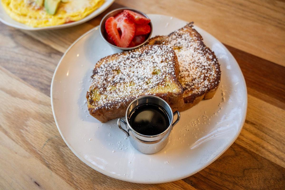 HomeGrown’s Cinnamon Swirl French Toast is dusted with powdered sugar and comes with syrup and fresh strawberries.
