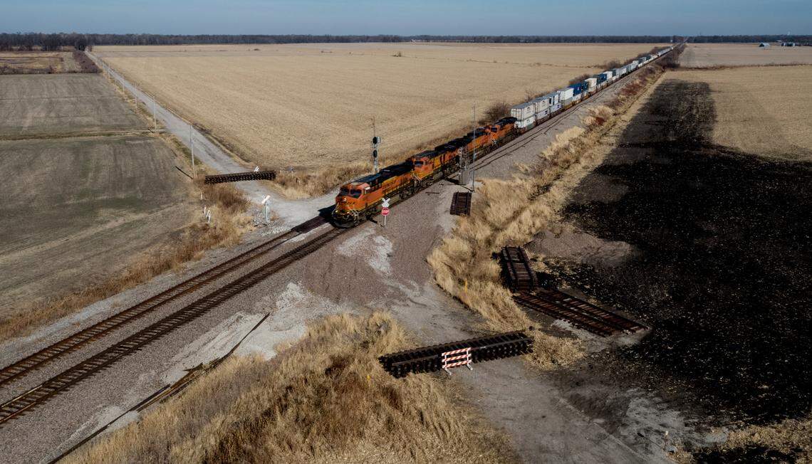 In late November, a freight train is seen traveling through the crossing near Mendon, Missouri, where a June crash killed four people and injured more than 150. The crossing is still closed.