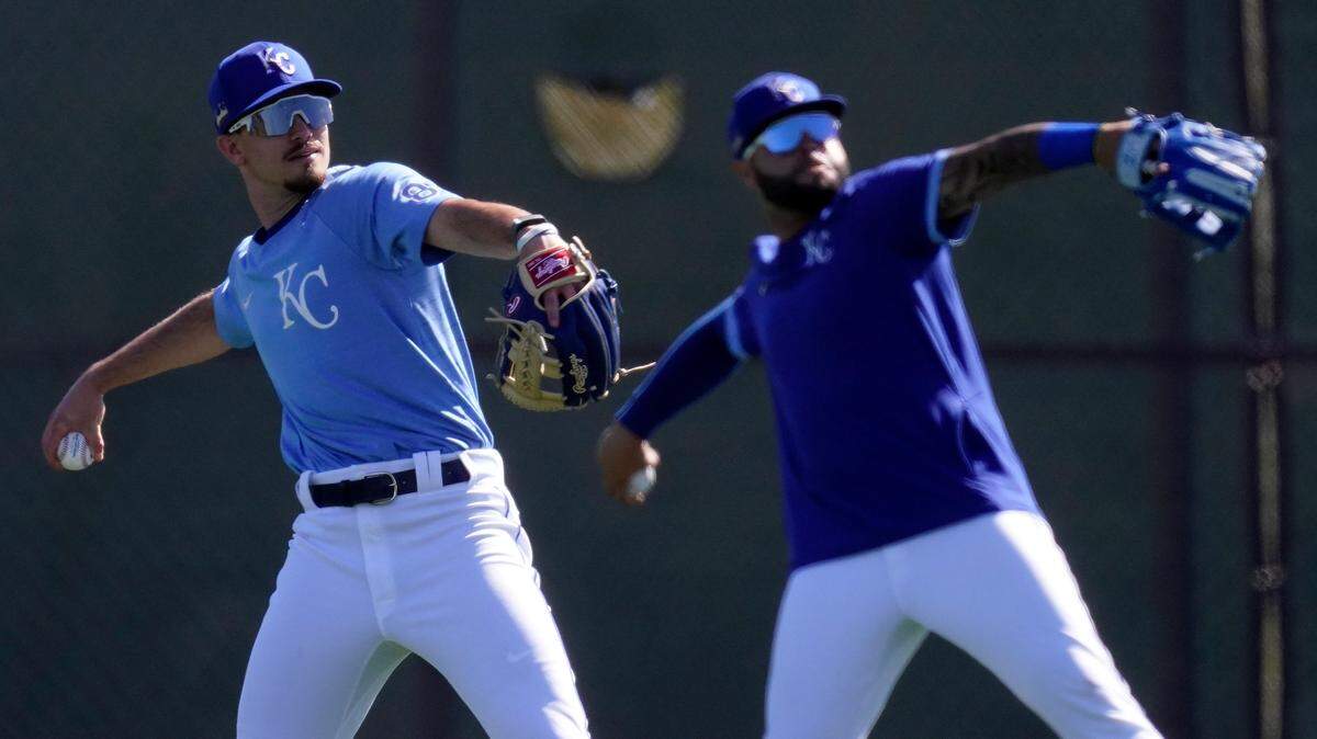 Kansas City Royals’ Nick Loftin, left, Emmanuel Rivera throw during spring training baseball practice Wednesday, Feb. 24, 2021, in Surprise, Ariz. (AP Photo/Charlie Riedel)