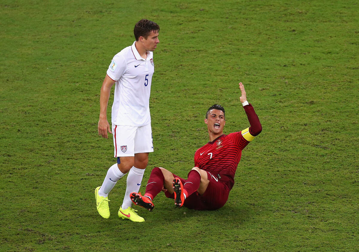 Cristiano Ronaldo of Portugal reacts as Matt Besler of the United States looks on during the 2014 FIFA World Cup Brazil Group G match between the United States and Portugal at Arena Amazonia on June 22, 2014 in Manaus, Brazil.