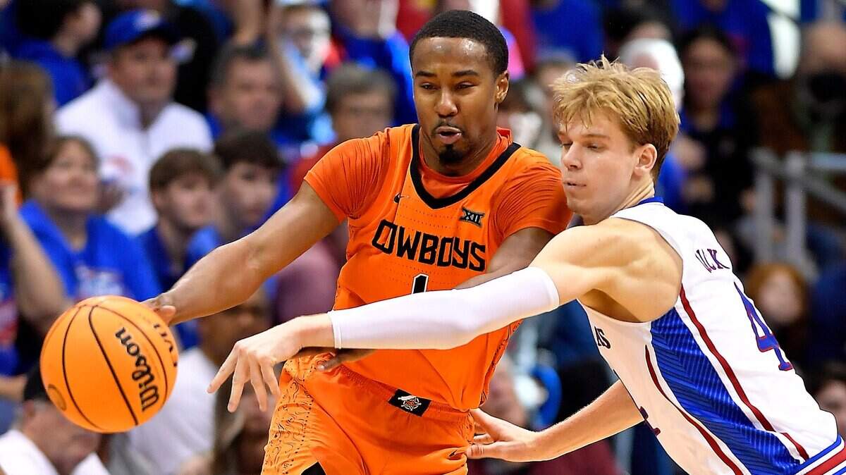KU’s Gradey Dick (right) knocks the ball away from Oklahoma State’s Bryce Thompson during the second half of Saturday’s Big 12 Conference game at Allen Fieldhouse. KU beat Oklahoma State 69-67.