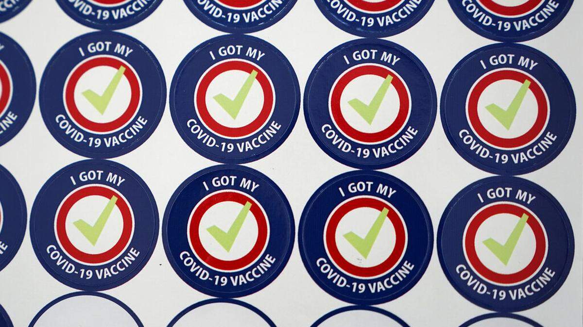 Stickers given to people getting vaccinated for COVID-19 are shown Tuesday, Feb. 23, 2021, at the VA Puget Sound Health Care System campus in Seattle. (AP Photo/Ted S. Warren)