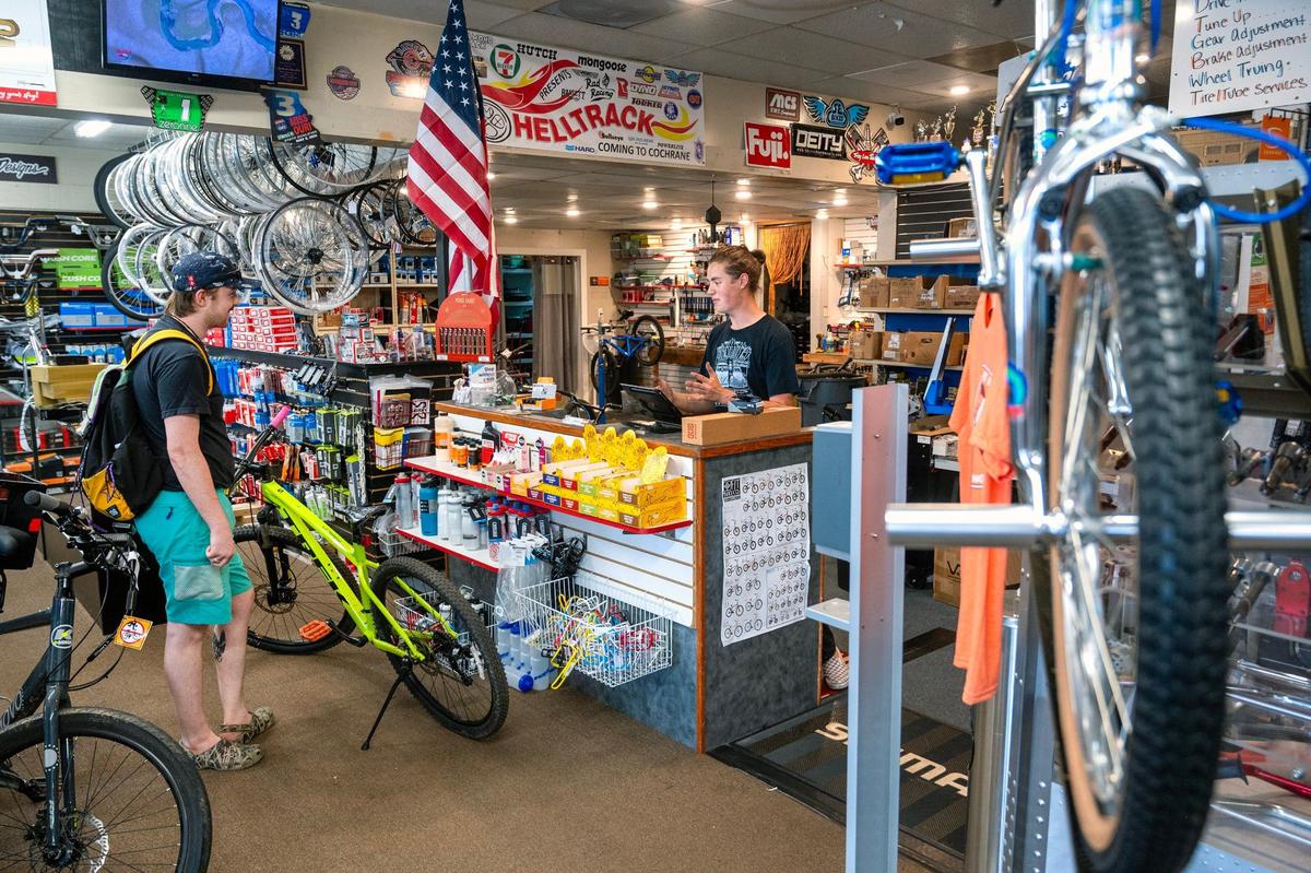 Joshua McCarty, left, of Olathe, talked with Jasper Vallad about installing a dropper post on his bike during a visit to Bikes for the Likes of Us, 108 S Clairborne Rd. The bike shop has been located there for nine years, but could now be forced to move.