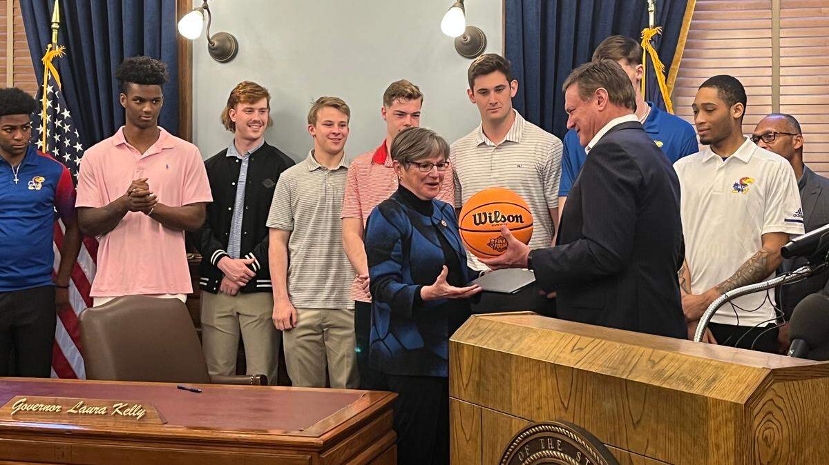 Kansas coach Bill Self presents Gov. Laura Kelly a basketball during a statehouse ceremony Monday honoring the Jayhawks’ NCAA championship season.