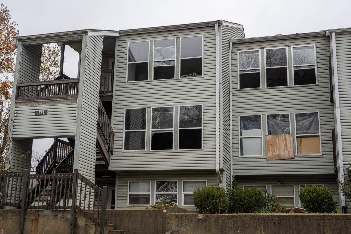 Broken and boarded-up windows are seen at Olive Park Village Apartments on Friday, Nov. 21, 2025, in Kansas City.