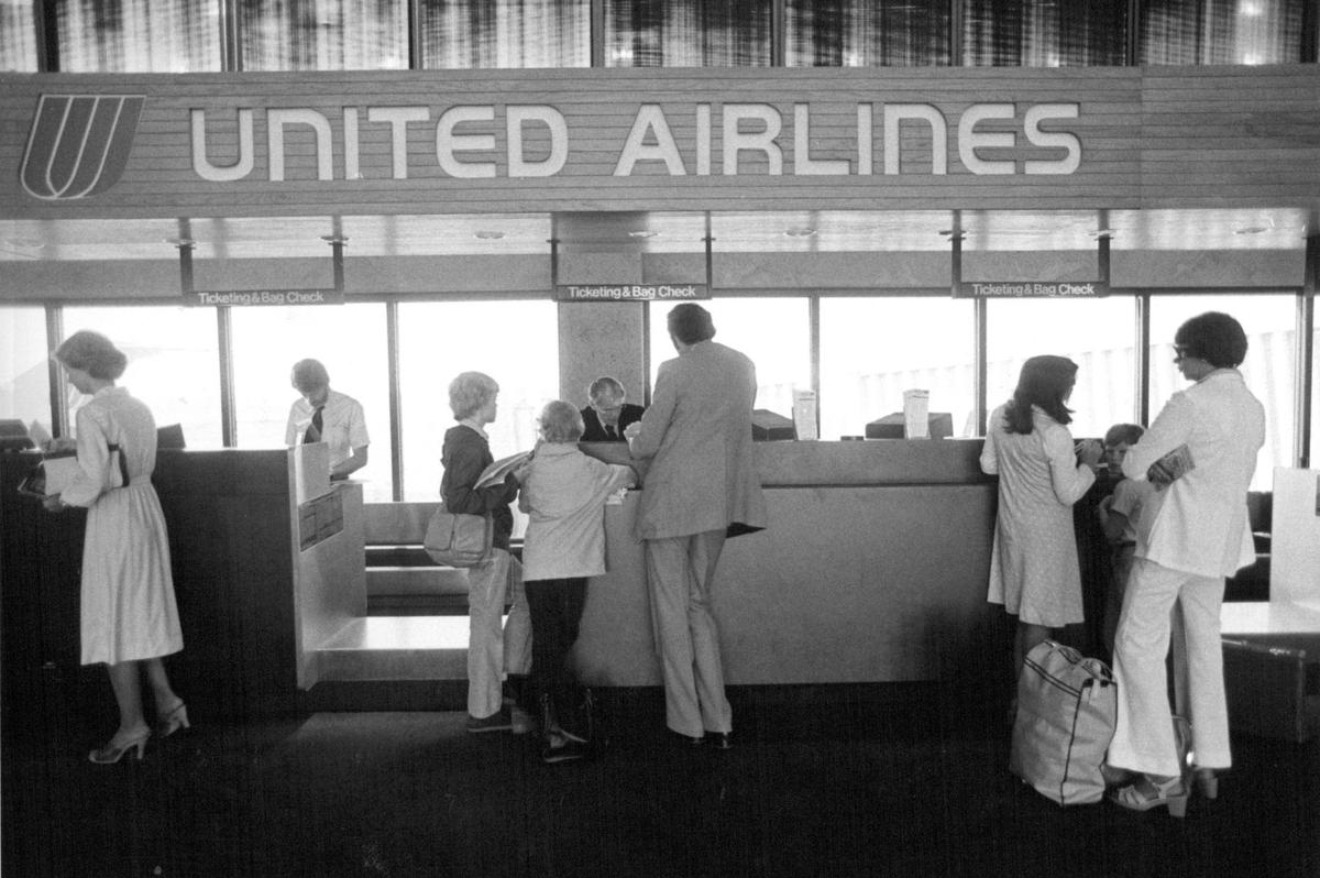 Air travelers check in at the United Airlines ticket counter at one of the Kansas City International Airport terminals.