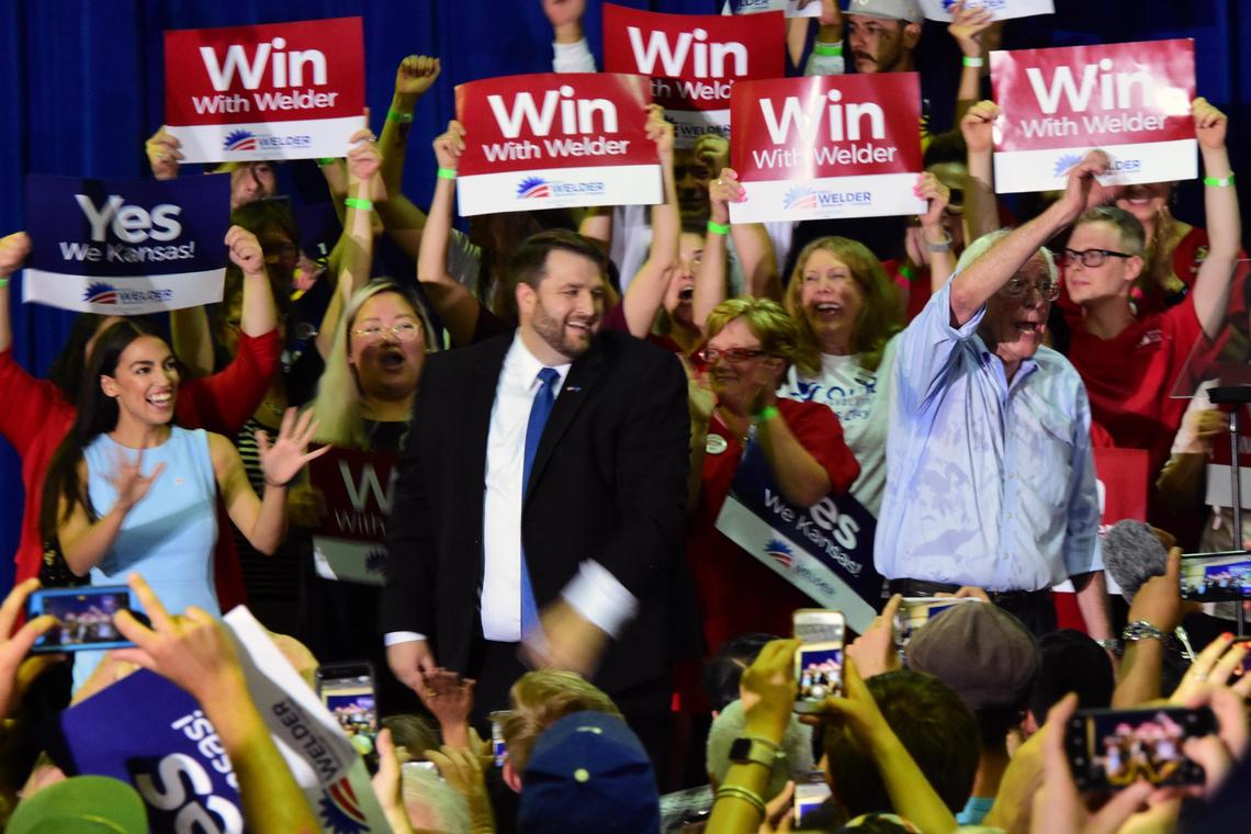 New York congressional candidate Alexandria Ocasio-Cortez and U.S. Sen. Bernie Sanders flank Brent Welder, a Democratic candidate for Kansas’ 3rd District congressional seat, at a July rally at Reardon Convention Center in Kansas City, Kan.