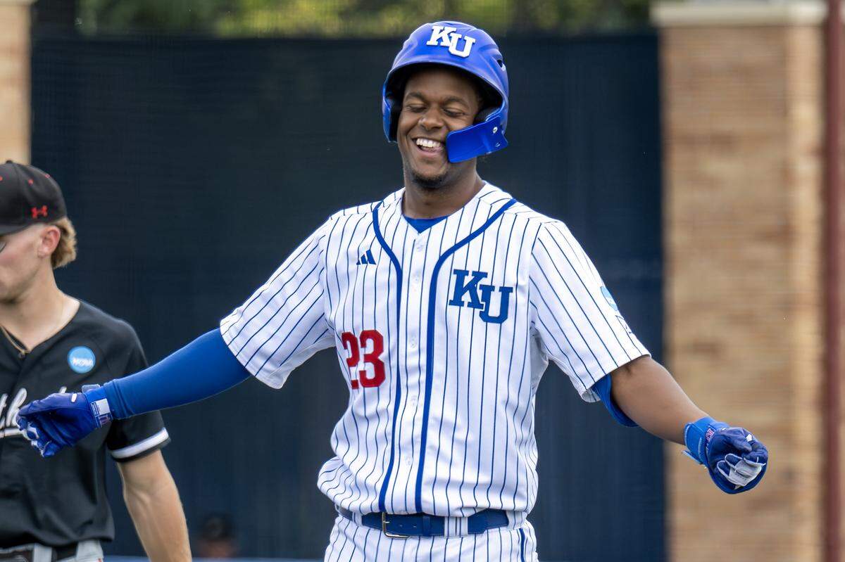 Kansas Jayhawks infielder Dariel Osoria (23) celebrates after hitting a double in the seventh inning against the Northeastern Huskies during an NCAA baseball tournament game at Hoglund Ballpark on Friday, May 29, 2026, in Lawrence.