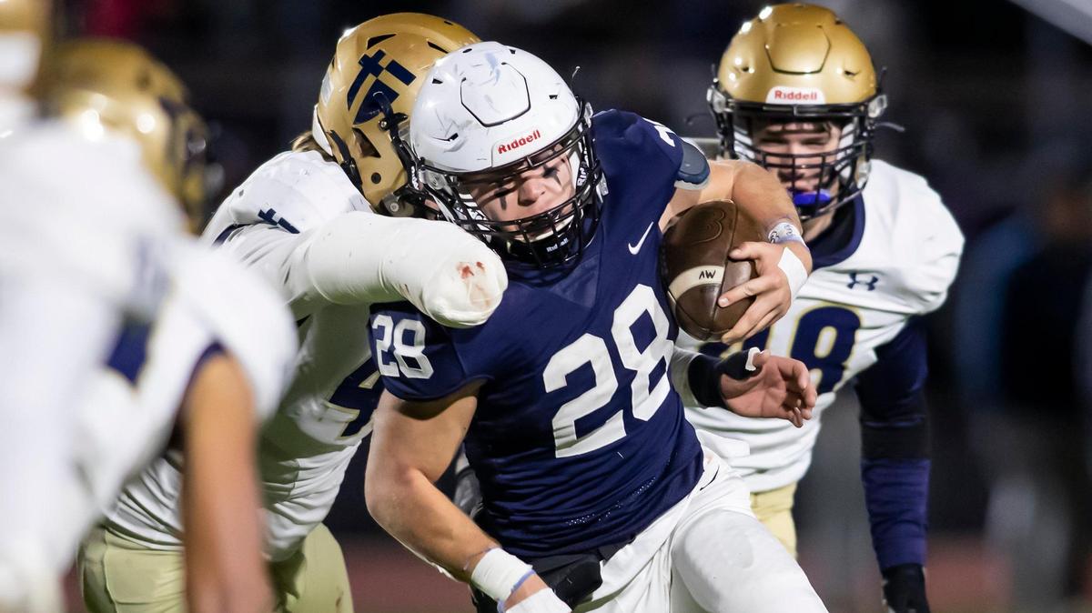 Mill Valley running back Reice Kennedy breaks through against the St. Thomas defense on Friday November 19, 2021 in Shawnee.