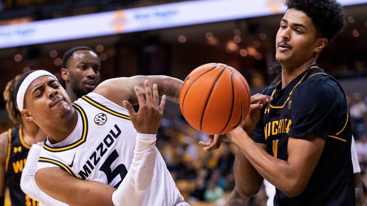 Missouri’s Jarron Coleman (left) and Wichita State’s Kenny Pohto vie for a rebound during the first half on Friday, Nov. 26, 2021, in Columbia, Mo.