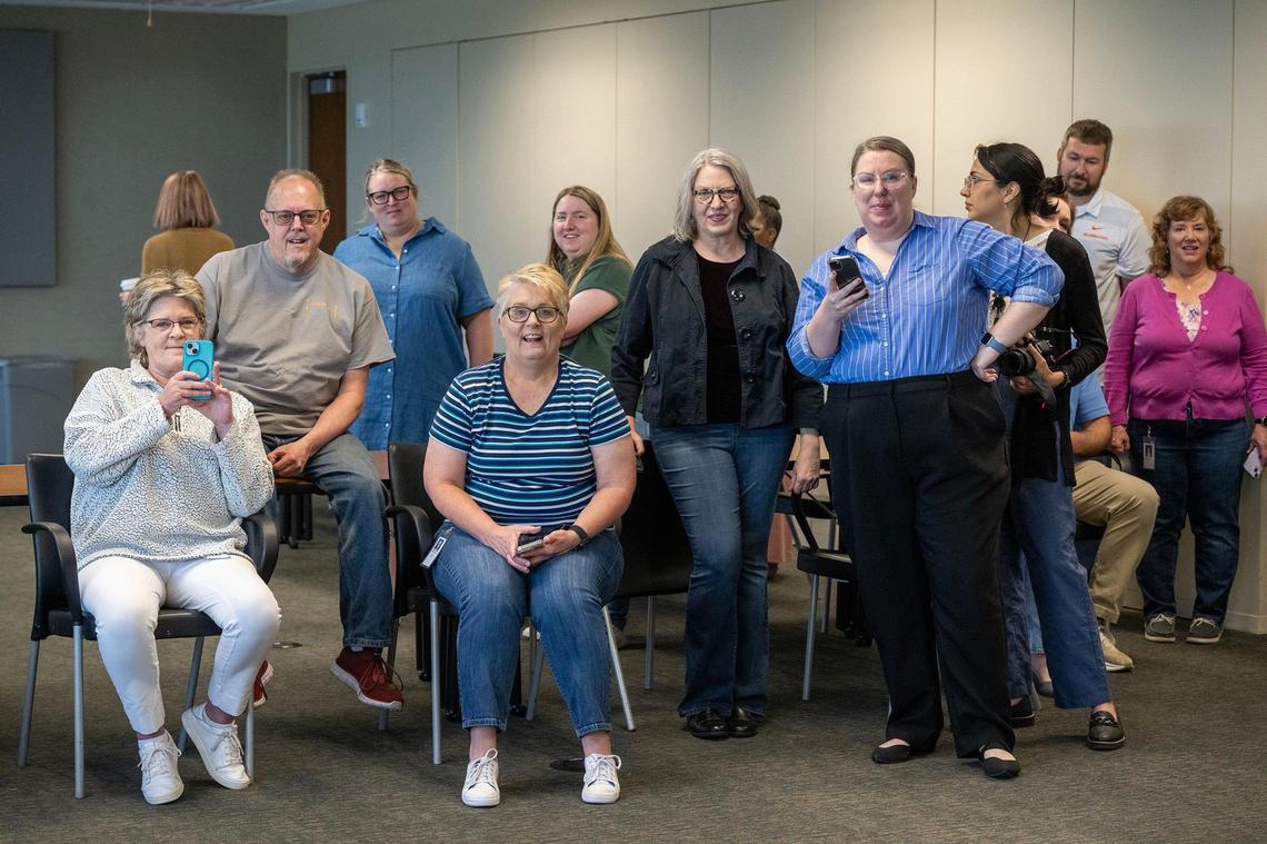 Employees from Shook, Hardy & Bacon watch as three Peregrine falcon chicks were banded in their office on Thursday, May 15, 2025, in Kansas City. The chicks hatched in a nest box on the roof of the Shook, Hardy & Bacon building in late March.