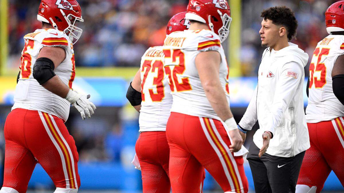 Kansas City Chiefs quarterback Patrick Mahomes (right) greets teammates on the sideline during the first half against the Los Angeles Chargers at SoFi Stadium.