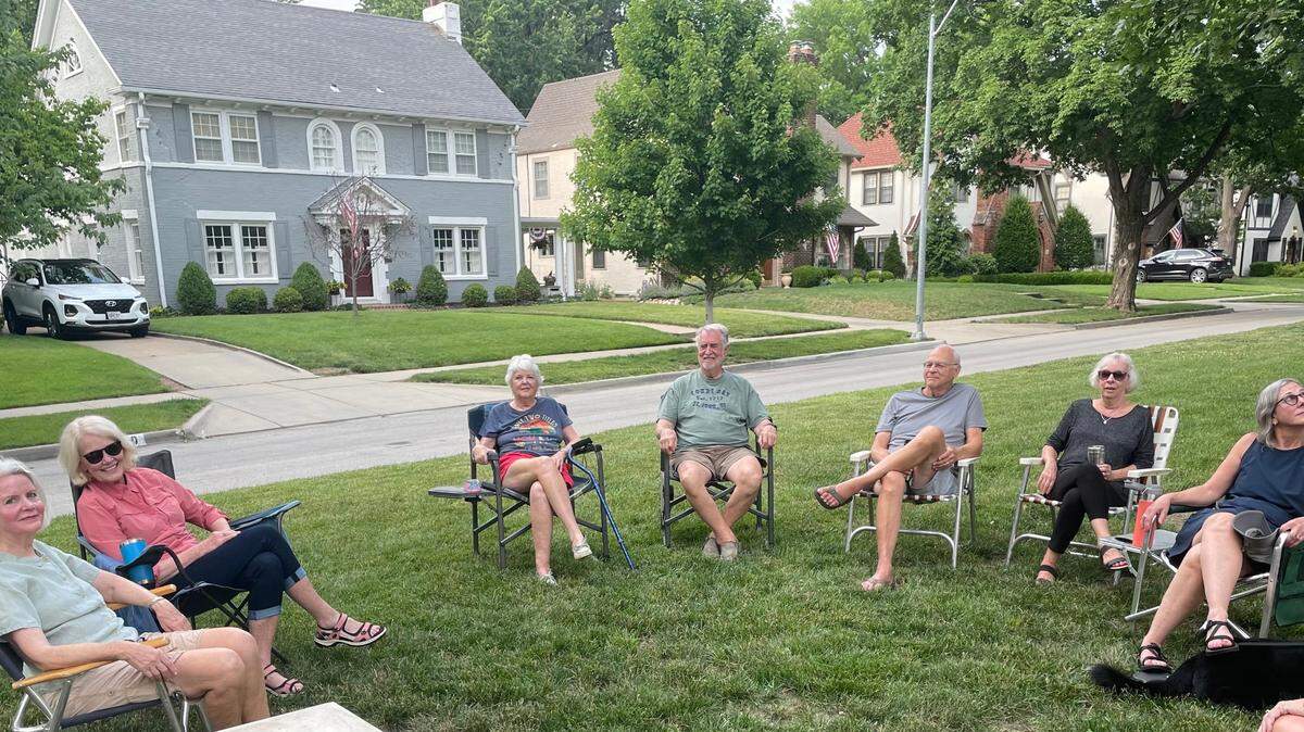 Residents of the 600 block of 70th Street in Brookside gather every Wednesday on the grass island that separates their homes. Lately, talk has turned to sharp assessment increases by the county on their homes.