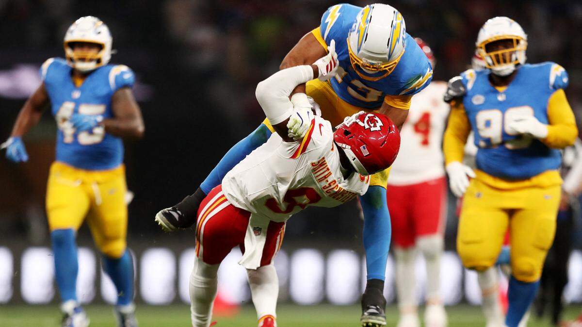 Los Angeles Chargers linebacker Troy Dye tackles Kansas City Chiefs wide receiver JuJu Smith-Schuster during the teams’ NFL season-opening game at Corinthians Arena in Sao Paulo, Brazil, on Friday, Sept. 5, 2025.