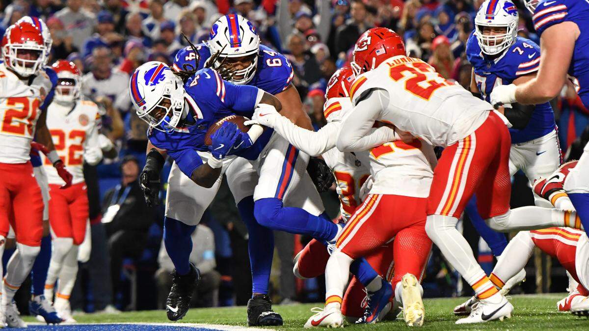 Buffalo Bills running back James Cook (4) scores a touchdown against the Kansas City Chiefs in the second quarter at Highmark Stadium.