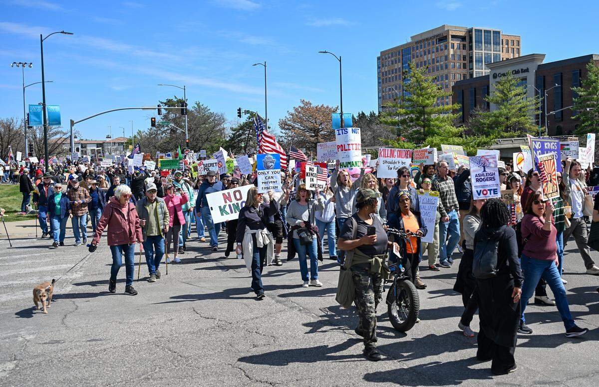 Protesters marched near the Country Club Plaza on Saturday, March 28, 2026, for a No Kings protest against the Trump administration in Kansas City.