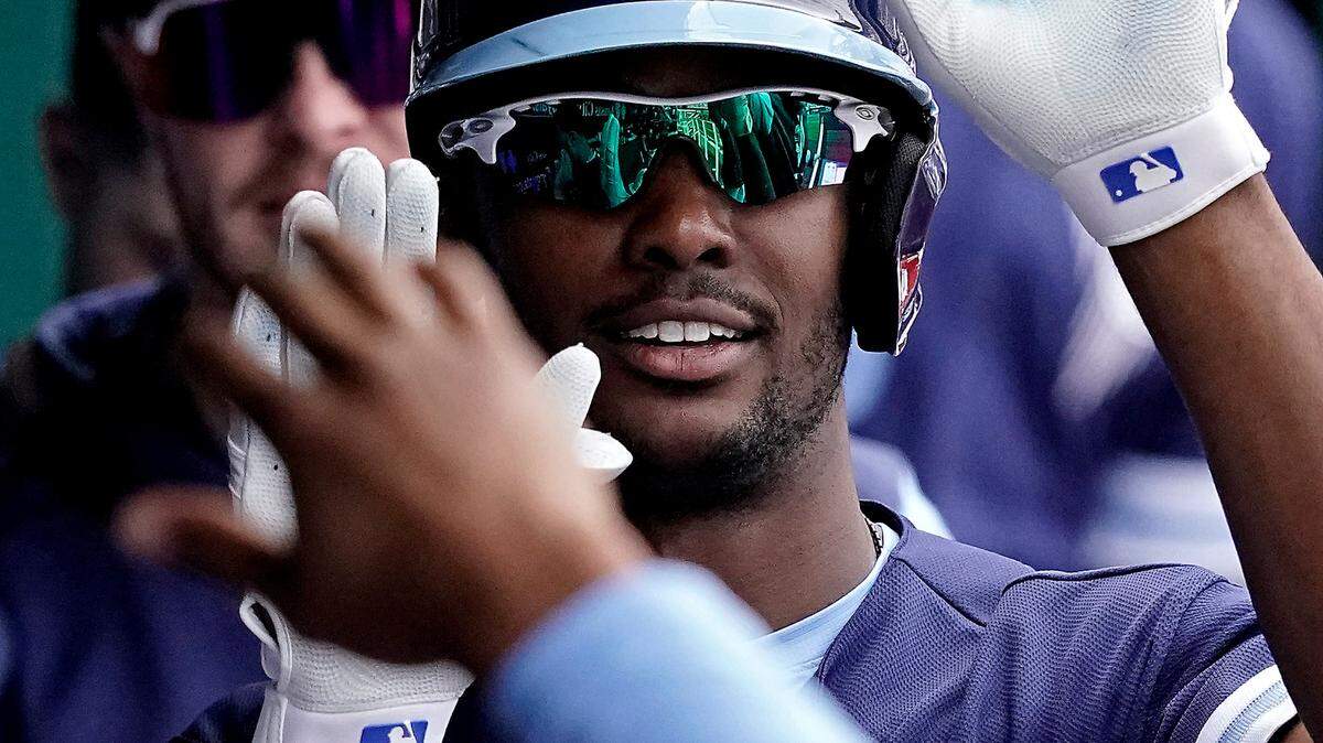 Kansas City Royals’ Michael A. Taylor celebrates in the dugout after hitting a solo home run during the third inning of a baseball game against the New York Yankees Sunday, May 1, 2022, in Kansas City, Mo. (AP Photo/Charlie Riedel)