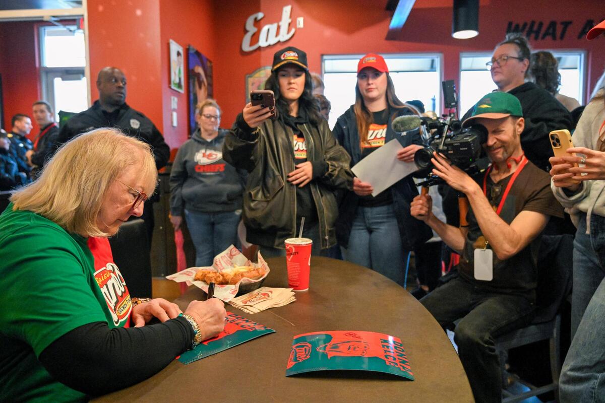 Donna Kelce autographed items during a visit to Raising Cane’s on Monday in Overland Park.