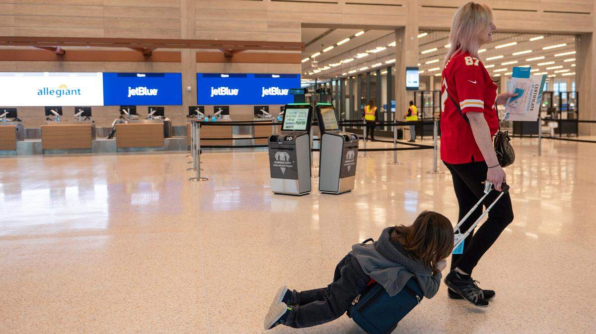 Rachelle Landreth, right, and her four-year-old son Ozzy Nacis, finish a simulation shakedown tour at Kansas City International Airport on Tuesday, Feb. 14, 2023, shortly before the new terminal opened to the public.