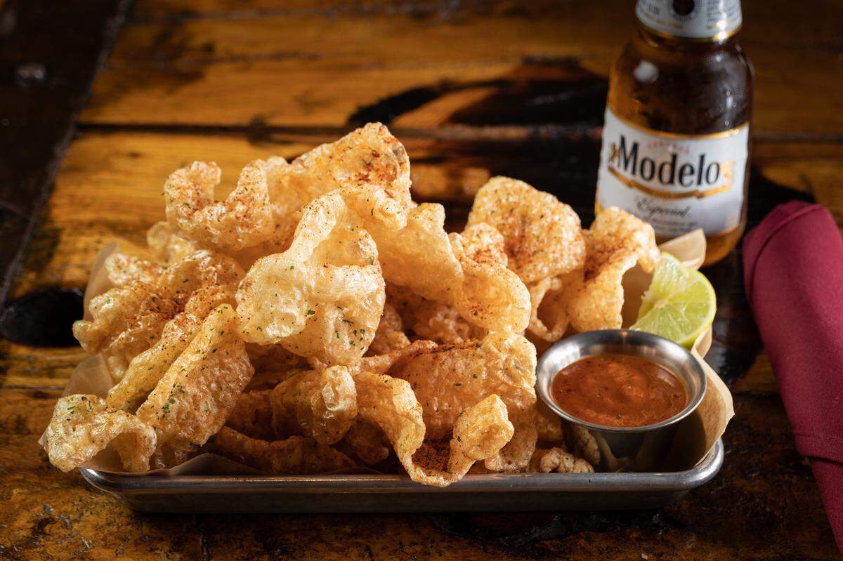 Twin Peaks’ fried pork rinds with spicy Cajun rub and Nashville hot sauce.