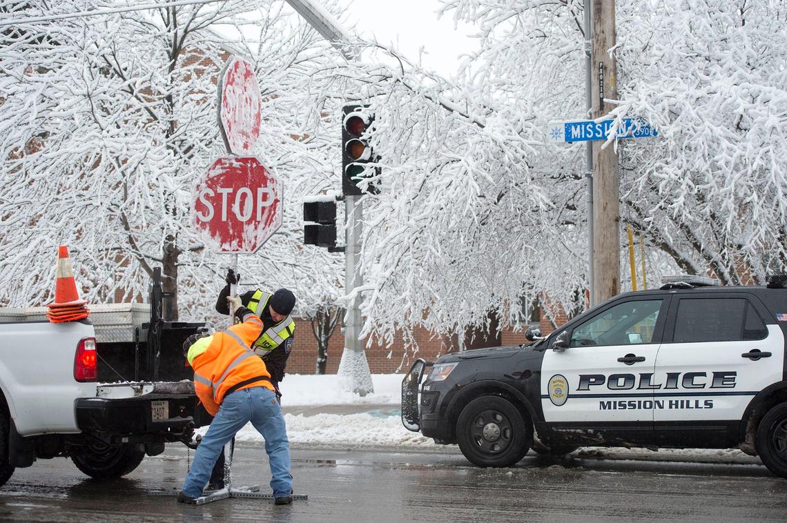 Snow blanketed the metro area leaving some areas, including parts of Prairie Village, without power Saturday morning. Prairie Village Police officer Ben Overesch and a public works employee put up a four-way stop at the intersection 67th Street and Mission Road, where the power was out.