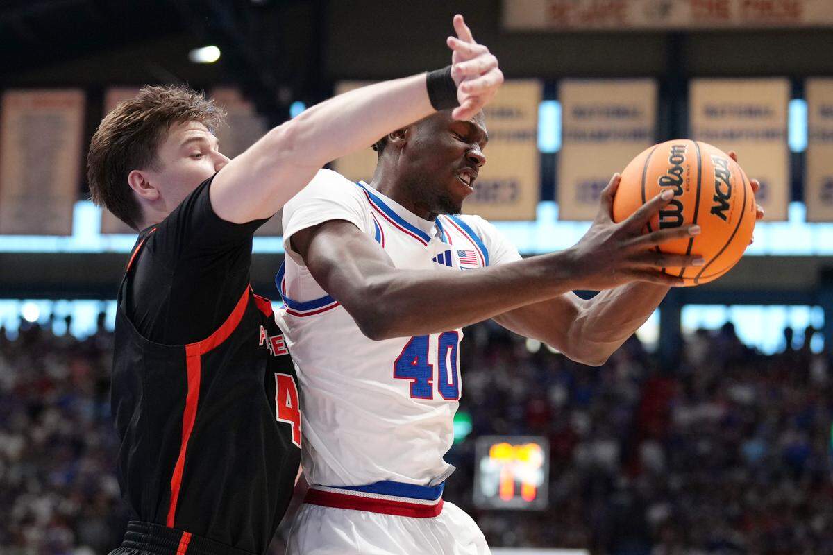 Flory Bidunga #40 of the Kansas Jayhawks rebounds against CJ Happy #4 of the Princeton Tigers in the first half at Allen Fieldhouse on November 15, 2025 in Lawrence.