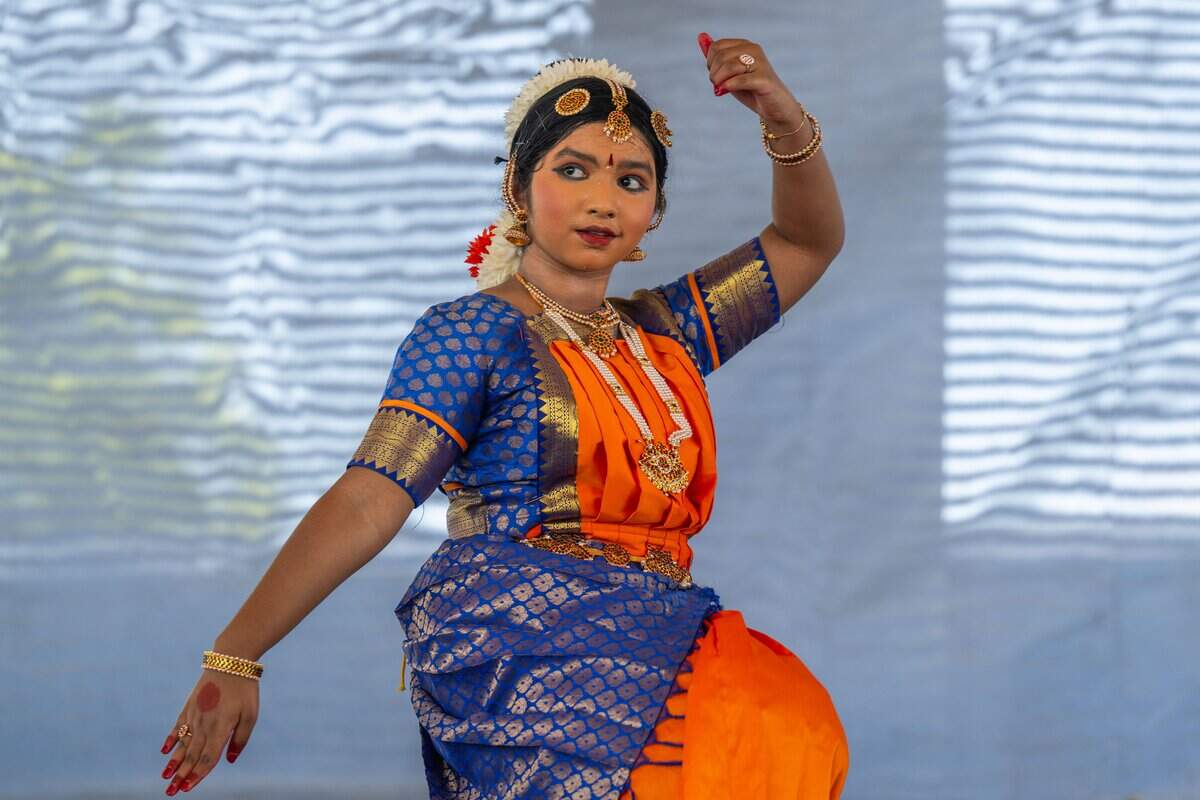Diya Kiran Krishnan performs a classical Bharatnatyam dance at the Ethnic Enrichment Festival in Swope Park on Saturday, Aug. 16, 2025, in Kansas City. The annual festival celebrates the many different cultures and ethnicities that exist in Kansas City, with vendor booths, cultural education opportunities, and performances. Temperatures reached nearly 100 degrees.