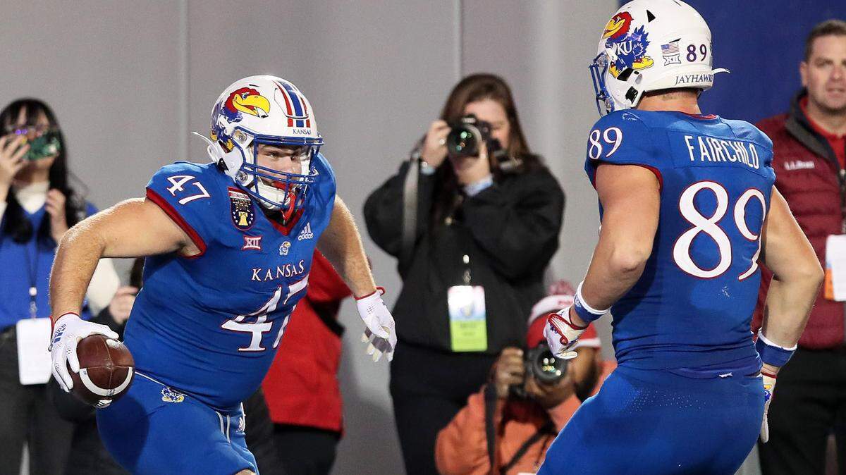 Kansas Jayhawks tight end Jared Casey, left, celebrates a second-overtime TD against Arkansas with teammate Mason Fairchild during the Liberty Bowl.