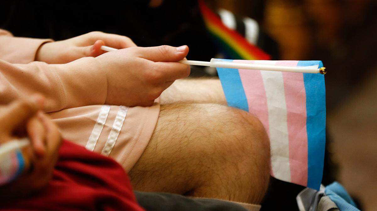 A person holds a transgender flag during the Equality Kansas Advocacy Day rally at the Statehouse on Jan. 31, 2024.