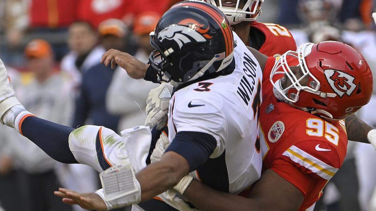 Chiefs defensive tackle Chris Jones (No. 95) sacks Denver Broncos quarterback Russell Wilson late in the game at GEHA Field at Arrowhead Stadium.