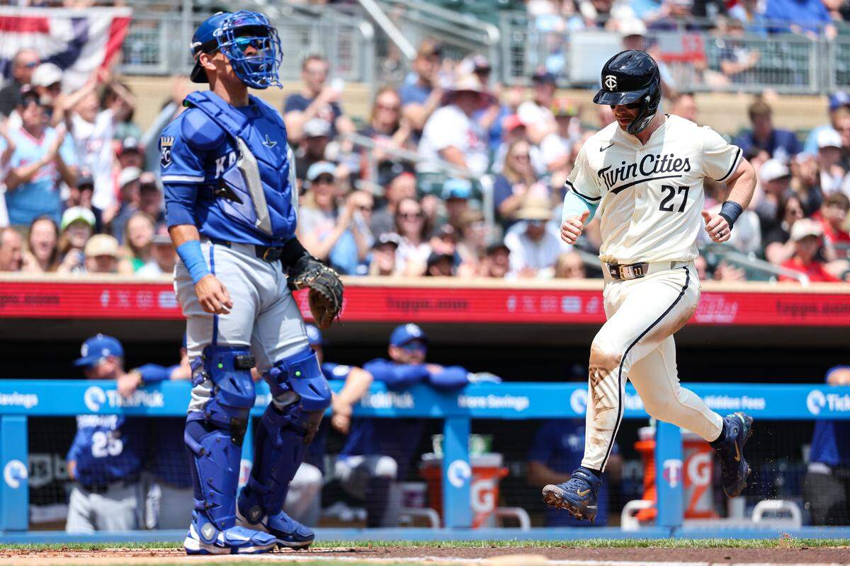 Minnesota Twins catcher Ryan Jeffers, right, scores on a single by first baseman Ty France during the first inning of a May 25, 2025 Major League Baseball game against the Kansas City Royals at Target Field in Minneapolis.