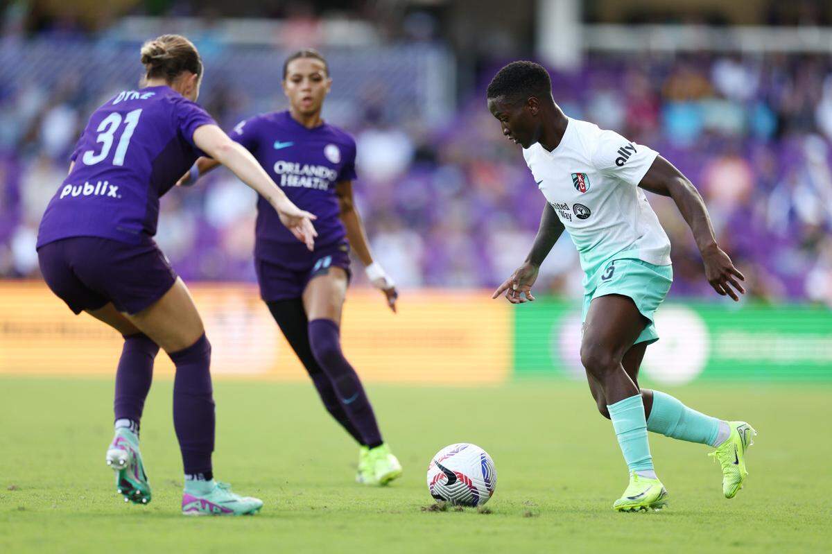 Kansas City Current forward Temwa Chawinga right confronts several Orlando Pride defenders during an NWSL playoff semifinal soccer match at Inter&Co Stadium in Orlando on Sunday, Nov. 17, 2024.