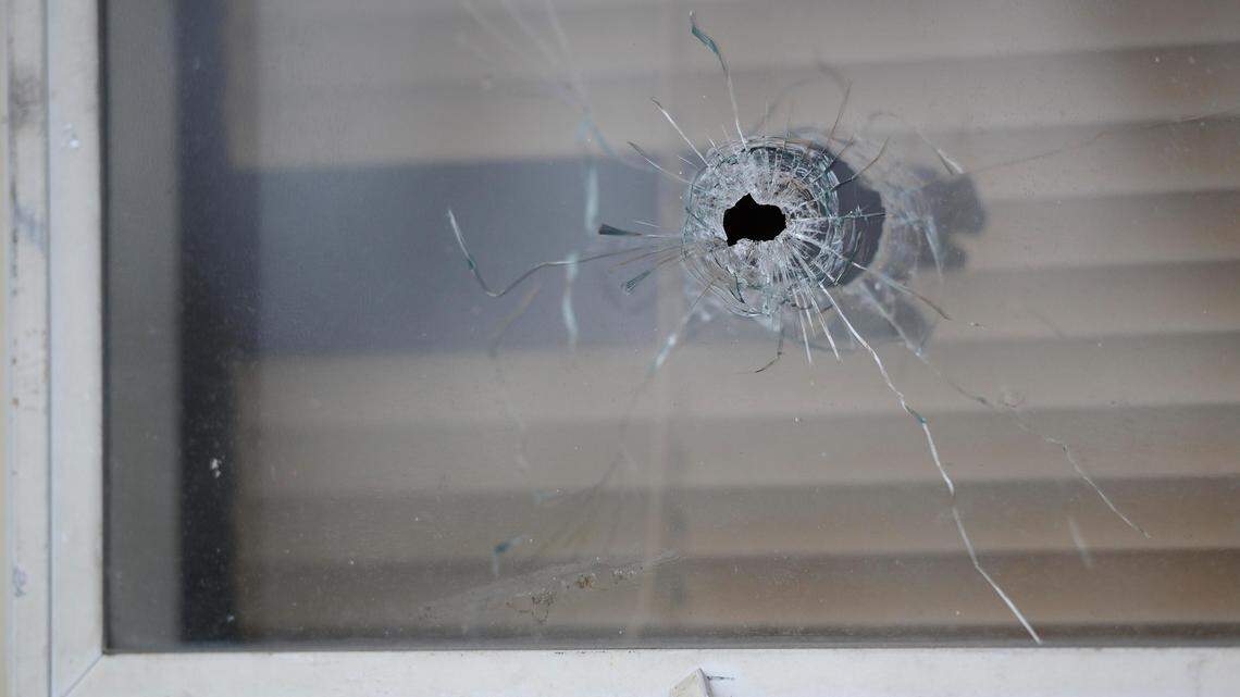 A bullet hole is seen in the window of a south Kansas City home where an 11-year-old girl was injured in a drive-by shooting. The shooting was reported about 11:15 p.m. Sunday in the 8500 block of East 92nd Place.