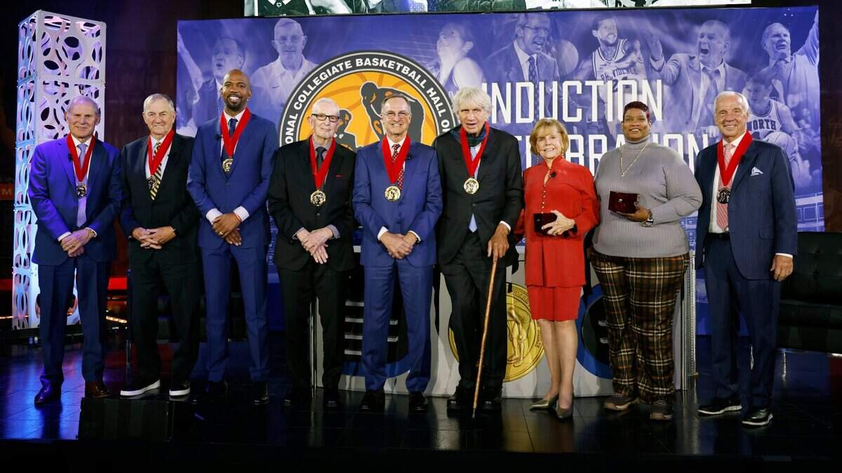 National Collegiate Basketball Hall of Fame inductees, from left; John Beilein, Jim Calhoun, Richard Hamilton, Jerry Krause, Lon Kruger, Larry Miller, Barbara Selvy, wife of Frank Selvy, Sonia Harrison, daughter of the late Jimmy Walker, and Roy Williams, pose for photos following an induction event on Sunday, Nov. 20, 2022, in Kansas City, Mo.