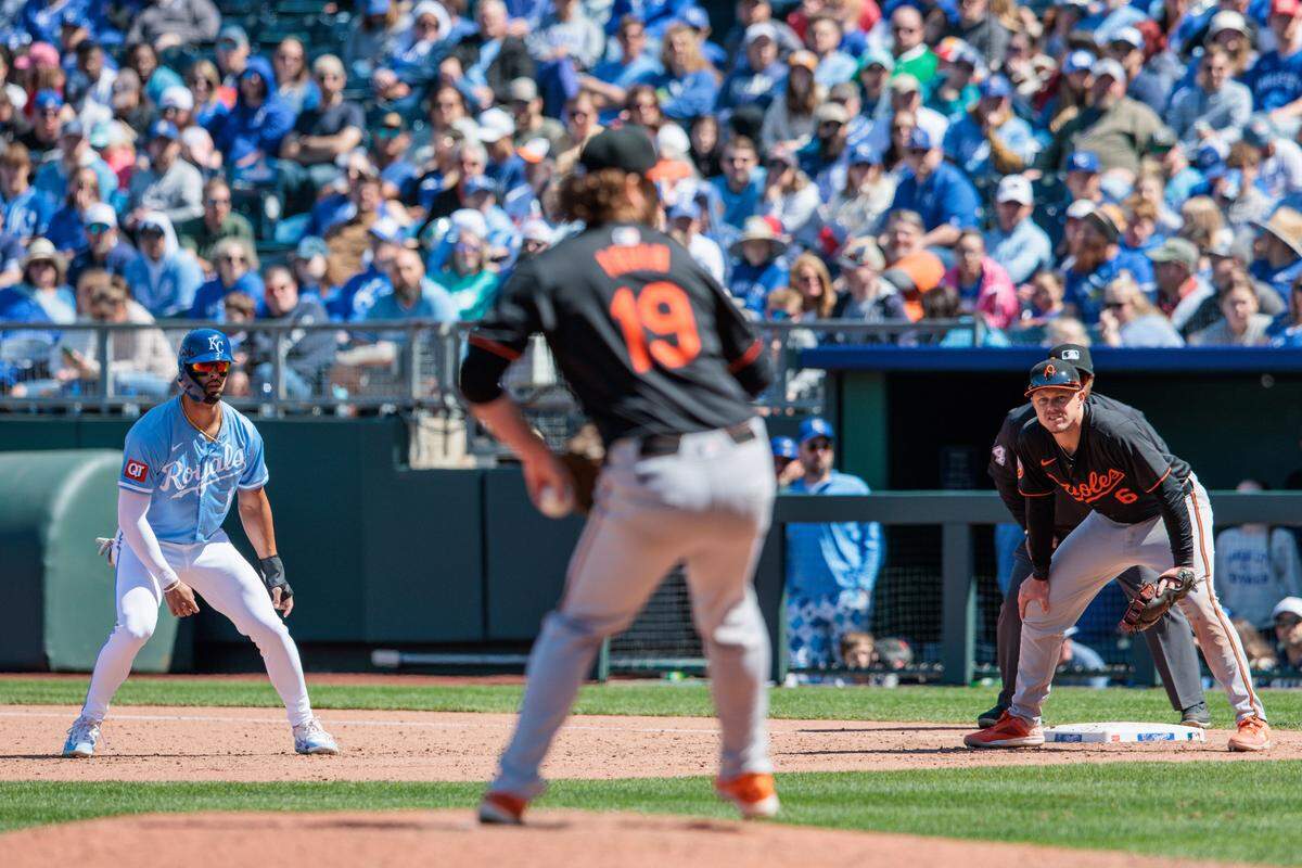 The Baltimore Orioles’ Cole Irvin (19) pitches as Kansas City Royals shortstop Bobby Witt Jr. (7) leads off first base during the sixth inning at Kauffman Stadium on April 21, 2024.