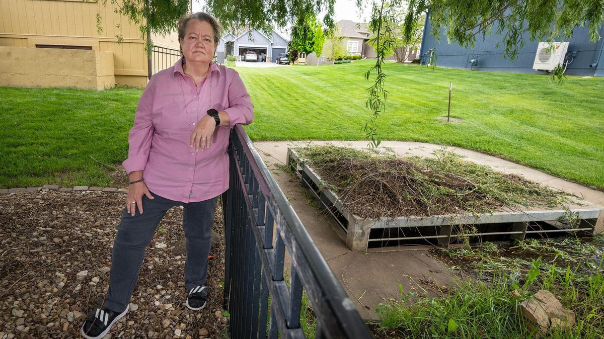 Kate Guimbellot’s dream home in the College Meadows neighborhood near College Boulevard and South Woodland Road in Olathe, has flooded three times in the past six years. Guimbellot says it’s due to faulty storm drain, right, which sits just outside her house. Guimbellot said the storm drain is too small to handle the runoff, she’s now fighting the city for a solution. She said the storm water drain was installed by the developer of the subdivision. Guimbellot was seen outside her home on Tuesday, May 6, 2025.