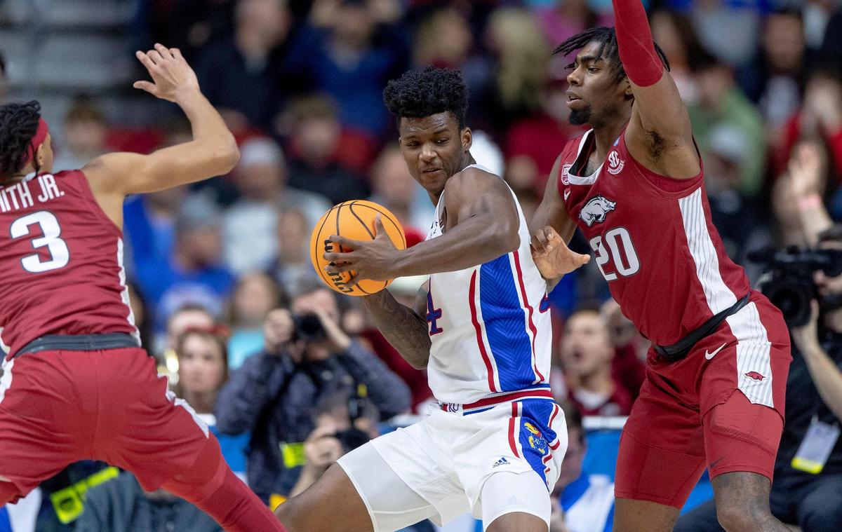 Kansas forward K.J. Adams Jr. (24) makes a move against Arkansas forward Kamani Johnson (20) during a second-round college basketball game in the NCAA Tournament Saturday, March 18, 2023, in Des Moines, Iowa.