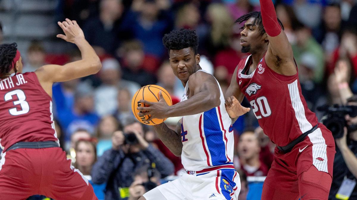 Kansas forward K.J. Adams Jr. (24) makes a move against Arkansas forward Kamani Johnson (20) during a second-round college basketball game in the NCAA Tournament Saturday, March 18, 2023, in Des Moines, Iowa.