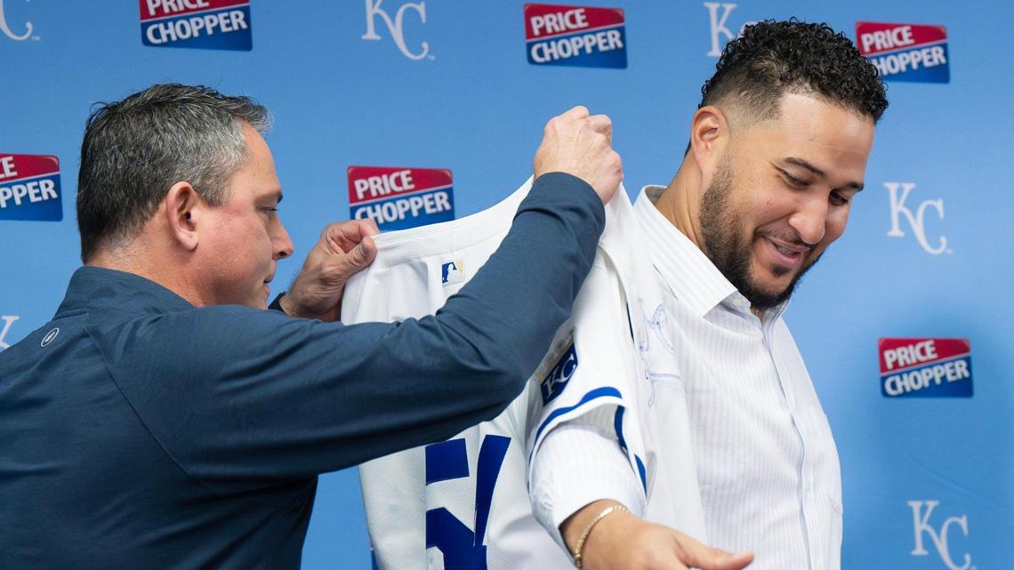 Royals general manager J.J. Picollo helps new pitcher Carlos Estévez don his jersey during a press conference at Kauffman Stadium on Saturday, Feb. 1, 2025, in Kansas City.