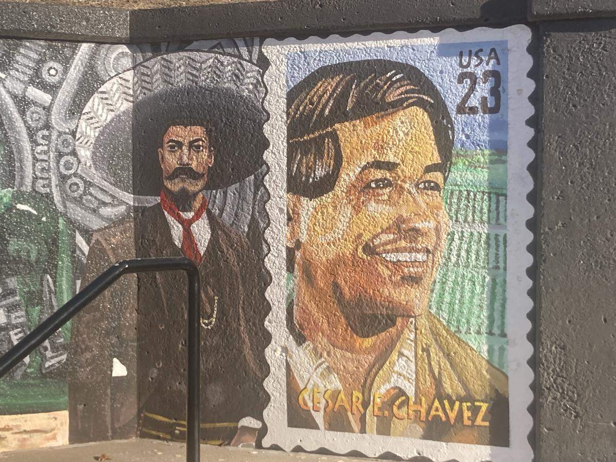 A portrait of Cesar E. Chavez as seen on the east side of a mural located on Avenida Cesar E. Chavez on the concrete steps leading to Gage Park.