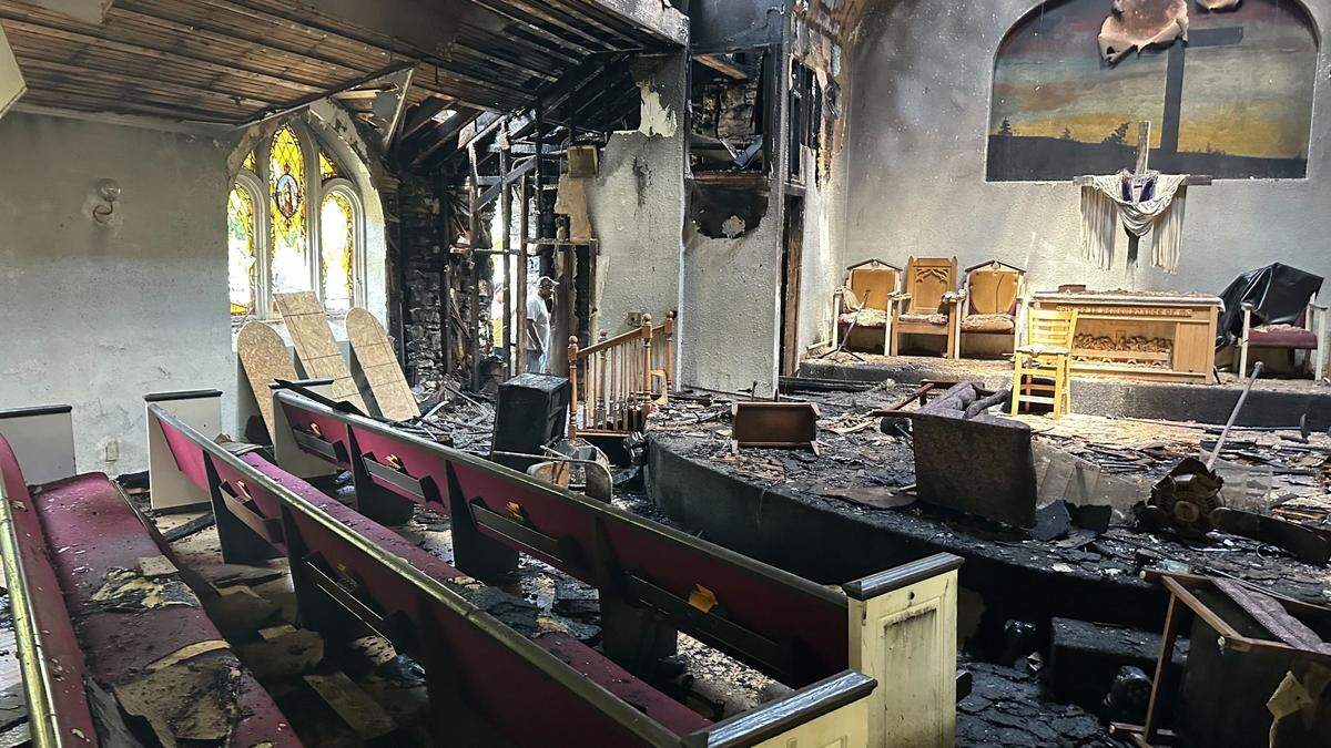 Pastor Willie Thornton took images of fire damage at the Mount Christian Worship Center later Wednesday after the Kansas City Fire Department cleared the area. The church currently is deciding on plans to repair or to rebuild.