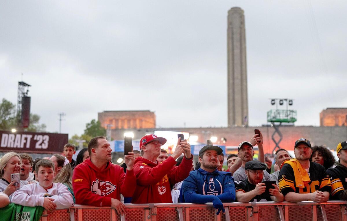 Football fans watch draft picks come in during the second round of the NFL Draft outside of Union Station on Friday, April 28, 2023, in Kansas City.